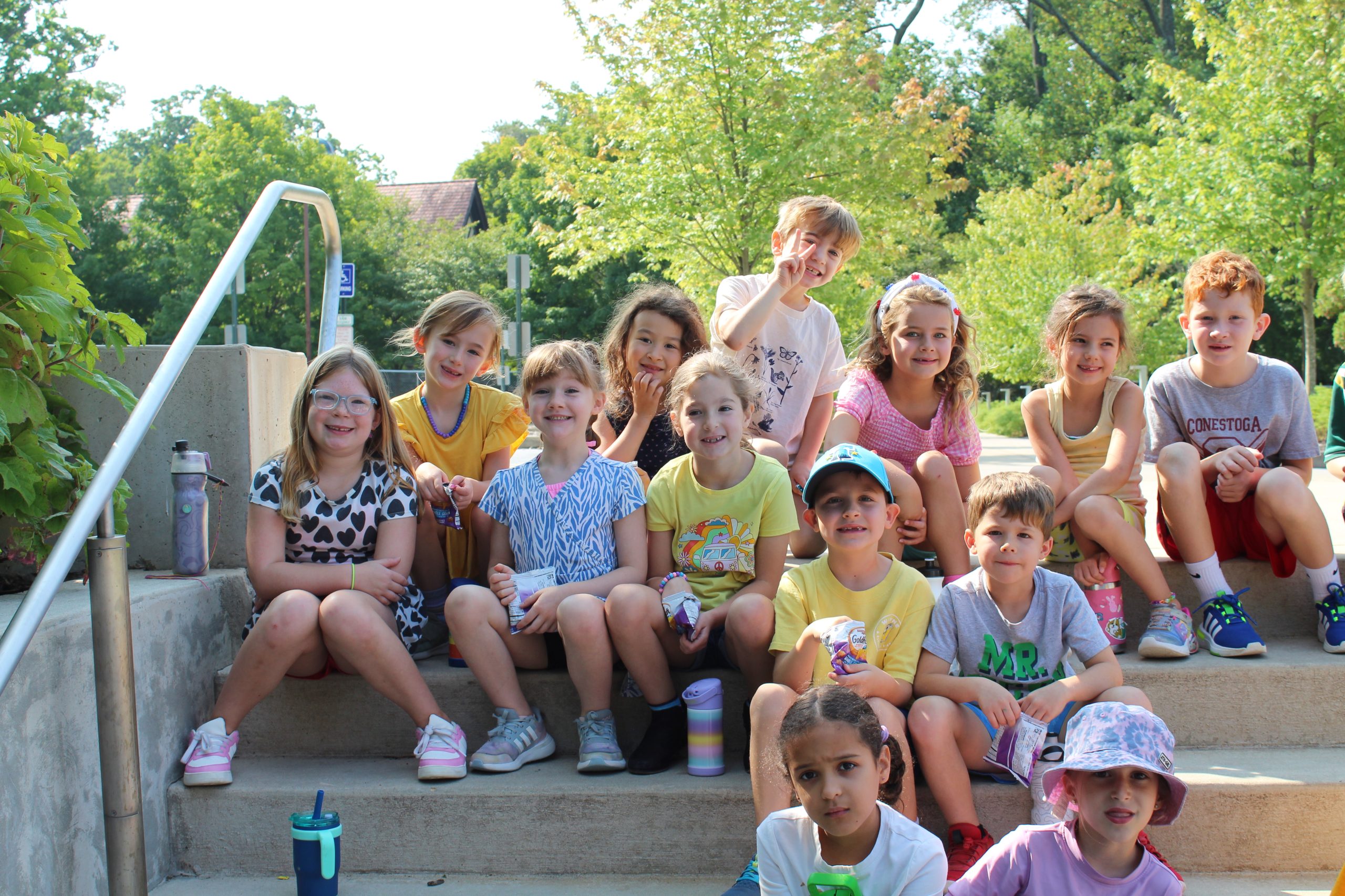 a group of young boys and girls at day camp during the summer